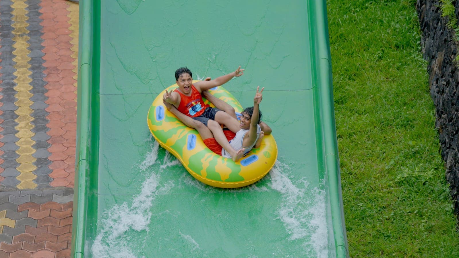 Green water slide raft ride at Flora Fantasia Kerala